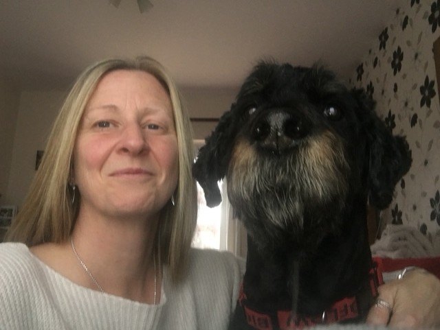 Christine at home with her own dog Alfie, a black-and-tan Rottweiler-cross.
